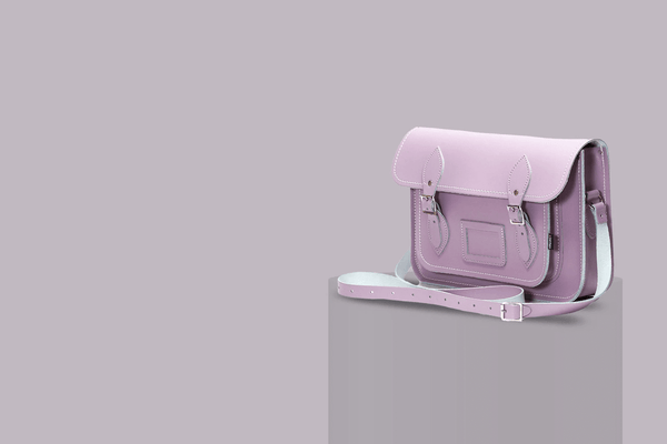handmade leather satchel in pastel violet on a grey background