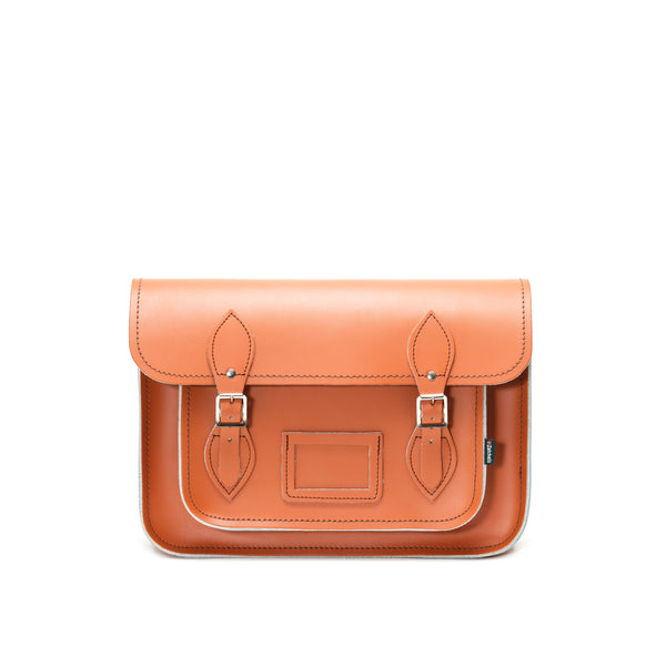 This image shows the front of a burnt orange leather satchel on a white background
