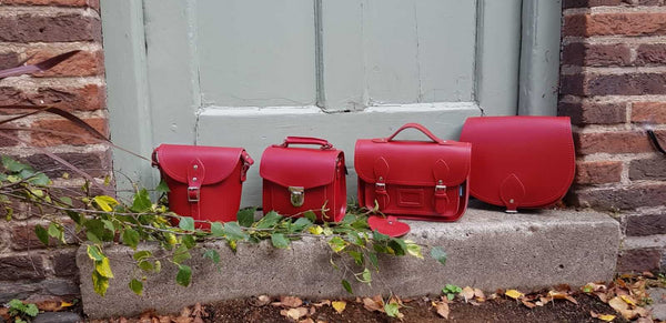 4 Zatchels Handmade Leather handbags In Red On A Stone Step