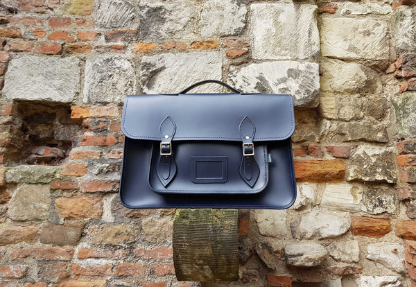 Navy Zatchels Classic Handmade Leather Satchel In Front Of A Stone Wall