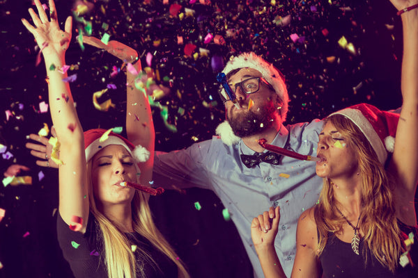 Three Young People Enjoying Themselves At A Christmas Party