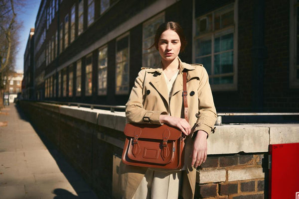 Woman with Zatchels handmade leather satchel laptop bag leaning on a wall