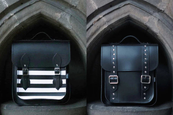 striped backpack and studded backpack placed in front of gothic alcoves