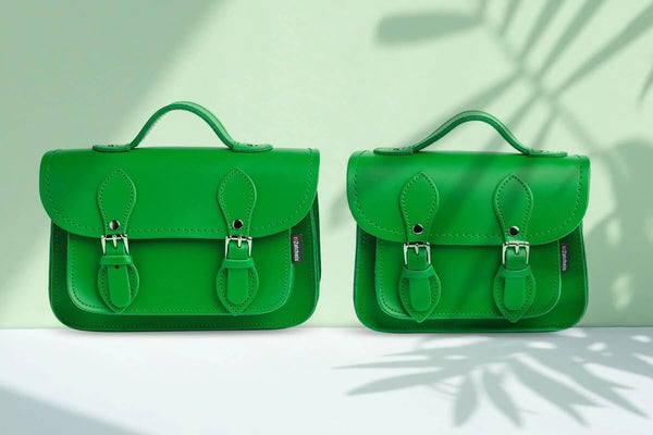 Zatchels micro satchel and micro satchel plus in green on a light green background with shadow of a plant