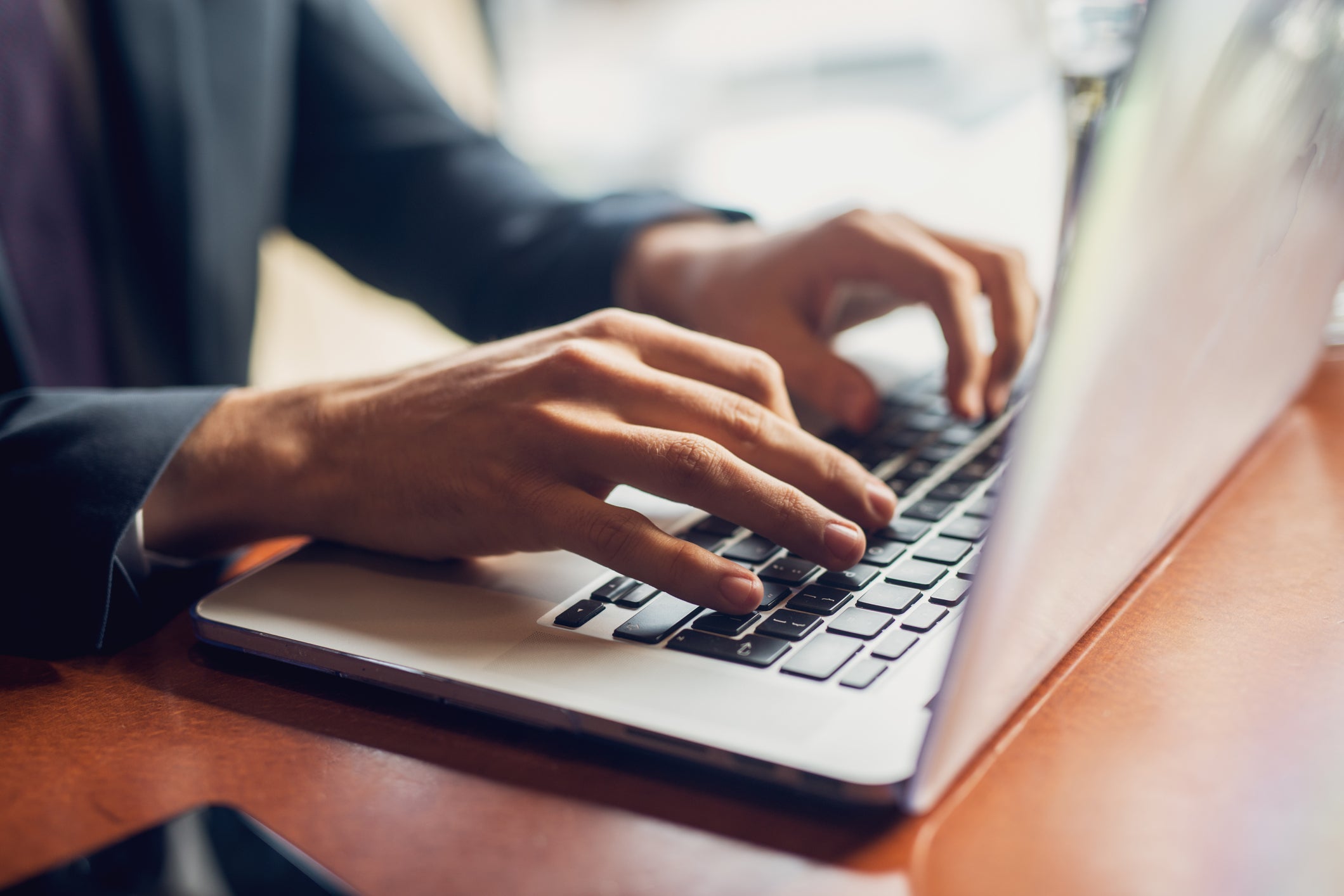 person typing on laptop