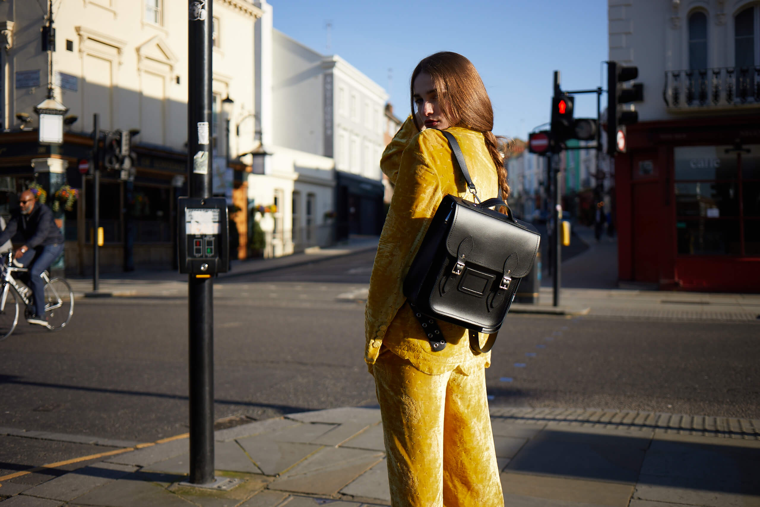 woman at a crossroad with a city backpack